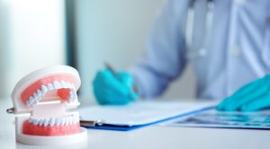The dentist is writing a summary report in his lab.