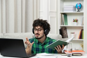 student-online-cute-young-guy-studying-computer-glasses-green-shirt-explaining-class (1)