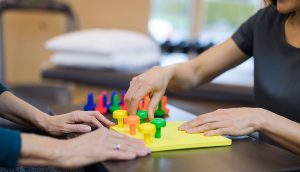 Occupational therapist works with a senior woman